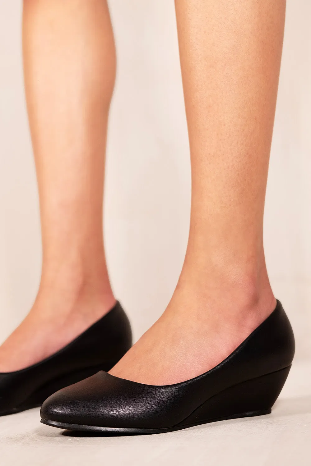 KIERAN PLATFORM LOW WEDGE MID HEEL COURT SHOES IN BLACK FAUX LEATHER